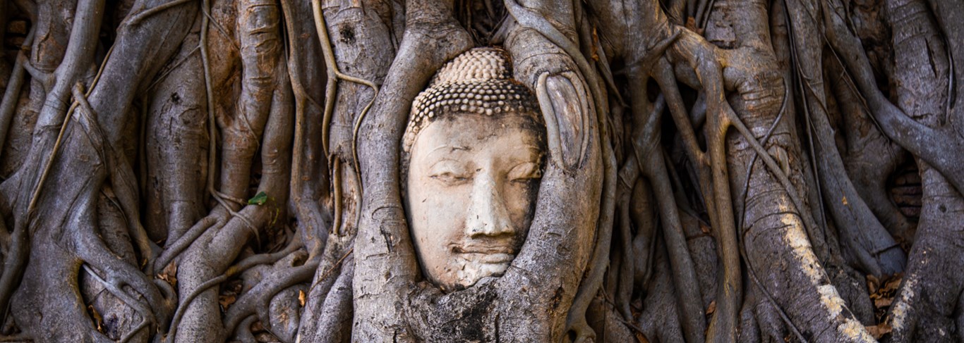 Wat Phra Mahathat temple with head statue trapped in bodhi tree in Ayutthaya